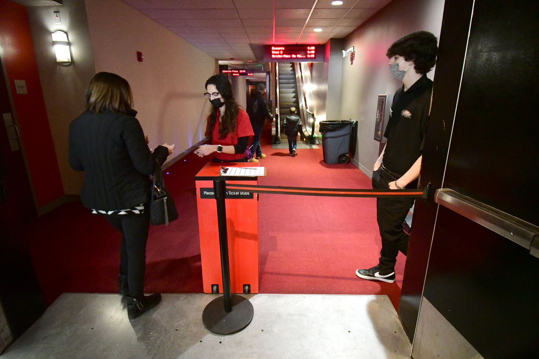 An employee checks movie tickets